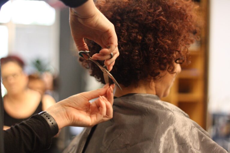 Woman with curly hair getting a haircut. This salon has curly hair expertise.