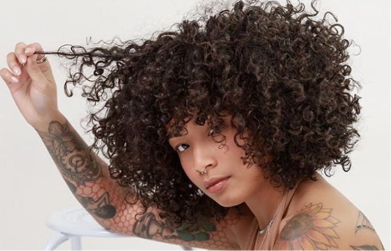 A photo of a young woman with curly hair. This salon has experts in curly hair cutting and styling.