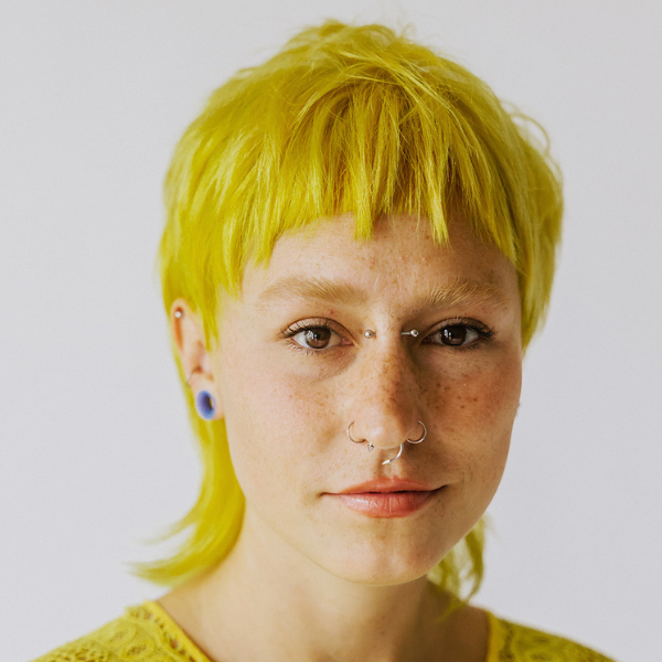 A young woman with an alternative hair cut and color. This salon experiments with edgy, modern hairstyles.